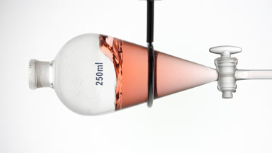 Red raspberry extract splash in separatory funnel dynamic view