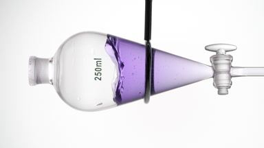 Lavender hydrosol splashing in separatory funnel, dynamic liquid