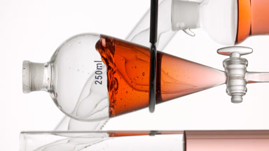 Orange liquid injected, significant splashes on white background