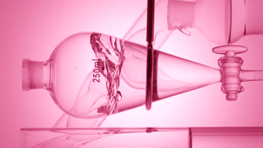 Clear liquid injected, waves form on pink ramp background