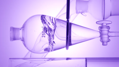 Violet liquid injection creates waves on purple ramp background