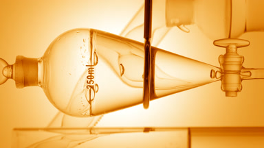 Clear liquid drains from funnel, bubbles rise on yellow ramp