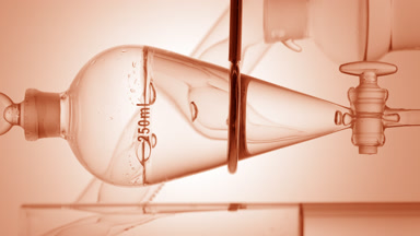 Clear liquid drains from funnel, bubbles rise on beige ramp