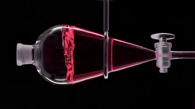 Cranberry extract injected in funnel, producing liquid splashes