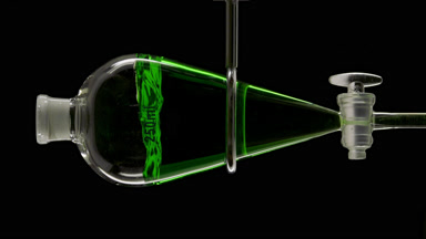 Chlorophyll solution injected forming striking splash in funnel