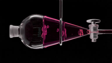 Purple carrot extract in vessel bubbles rising within the liquid