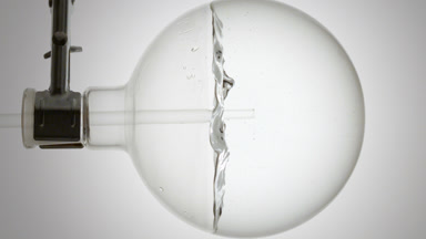 Sorbitol solution dropper into round flask swirling bubbles form