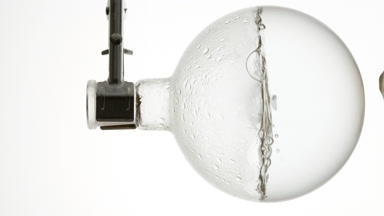 Bamboo water boiling in round flask, condensation on walls