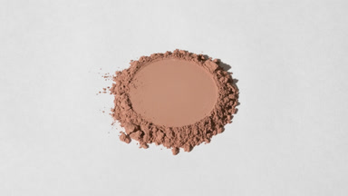 Brown Powder with Circular Mark on Light Gray Backdrop