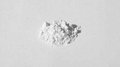 White Powder Pile on Gentle Grey Background