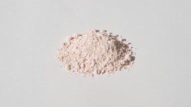 Arc Capture of Light Beige Powder on Dim Grey Background