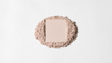 Beige Powder Mountain with Circular Imprint and Shifting Shadows