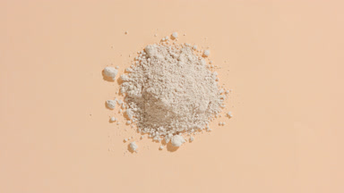 Beige Powder Pile Illuminated by Orbiting Light Source