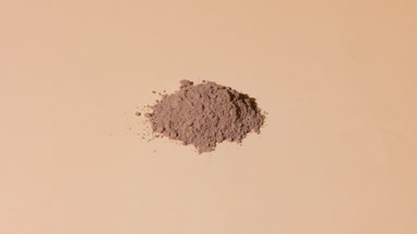 Stack of Brown Powder on Beige with Dynamic Shifting Light