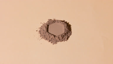 Curved Shot of Brown Powder with Hexagonal Impression
