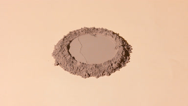 Wide Shot of Brown Powder with Round Imprint