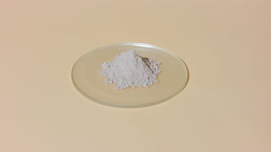Beige Powder on Watch Glass with Evolving Shadow