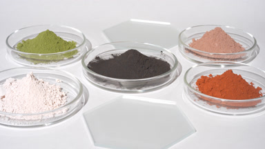 Vibrant Colored Powders in Petri Dishes with Light Effects