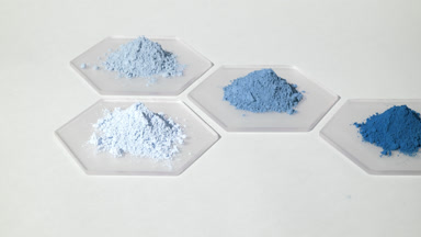 Wide Shot of Blue Cosmetic Powders on Hexagonal Glass