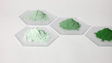 Tracking Shot of Green Powders on Hexagonal Glass