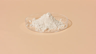 Light Beige Powder in Transparent Dish with Shifting Shadows