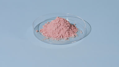 Pastel Pink Powder in Petri Dish on Pale Blue Surface