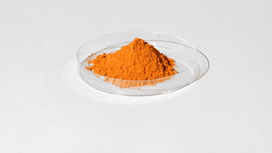 Orange Fine Powder in Petri Dish with Vivid Shadows