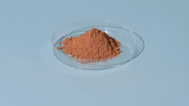 Brown Fine Powder in Petri Dish with Changing Shadows