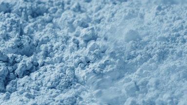 Macro View of Pale Blue Powder Blown by Air