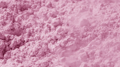 Close-Up Slow Motion of Pink Powder Disturbed by Air