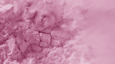 Extreme Macro of Crumbled Pink Powder Surface in Motion