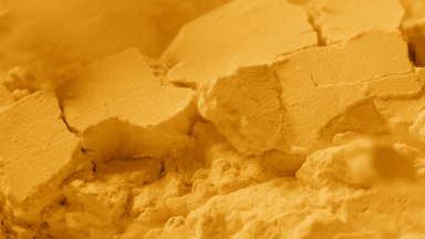 Macro Slow-Motion of Shattered Yellow Powder Surface