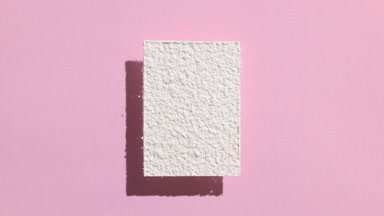 Dynamic White Powder Shadow on Pale Pink Background