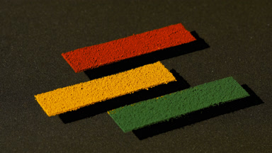 Vertical Arc of Colorful Powder on Transparent Surface