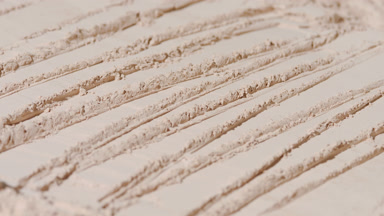 Dynamic Shadows on Beige Powder Surface with Knife Texturing