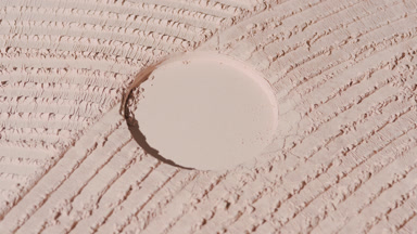 Beige Powder Surface with Shifting Shadows and Highlights