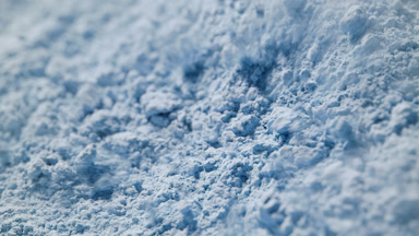Air Stream Disturbing Pale Blue Powder in Slow Motion
