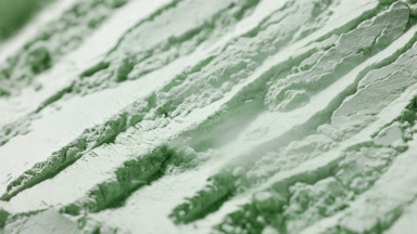 Slow Motion Air Stream Unveils Ridges in Green Powder