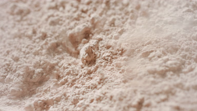 Macro Slow Motion of Air Blown Beige Powder for Kaolin Clay