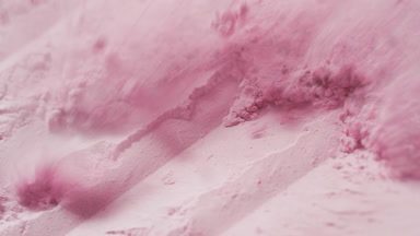 Extreme Close-Up of Pink Powder Layer Blown Off