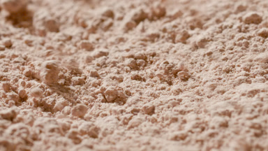 Extreme Macro of Beige Powder Disturbed by Airflow