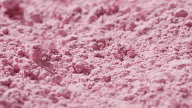Detailed Slow-Motion View of Pink Powder Disturbance