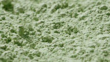 Pale Green Powder Disturbed by Wind in Close-Up