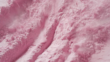 Extreme Close-Up of Air Stream on Pink Powder Surface