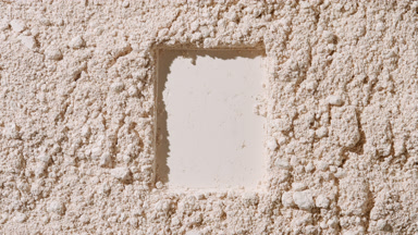 Beige Powder Surface with Rectangular Imprint in Top-Down View