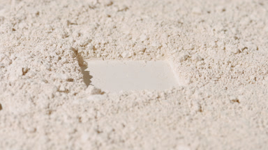Beige Powder Surface with Square Contour Imprint and Shadows