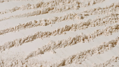Dynamic Beige Powder Surface with Parallel Strokes