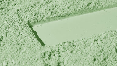 Fluid Shadows on Pale Green Powder Surface