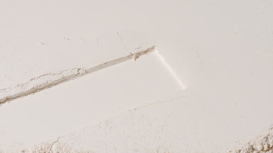 Beige Pressed Powder Surface with Dragged Imprint and Shadows