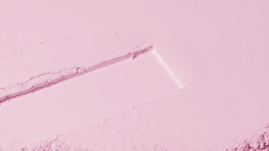 Dynamic Rose-Colored Powder Surface with Rectangular Mark